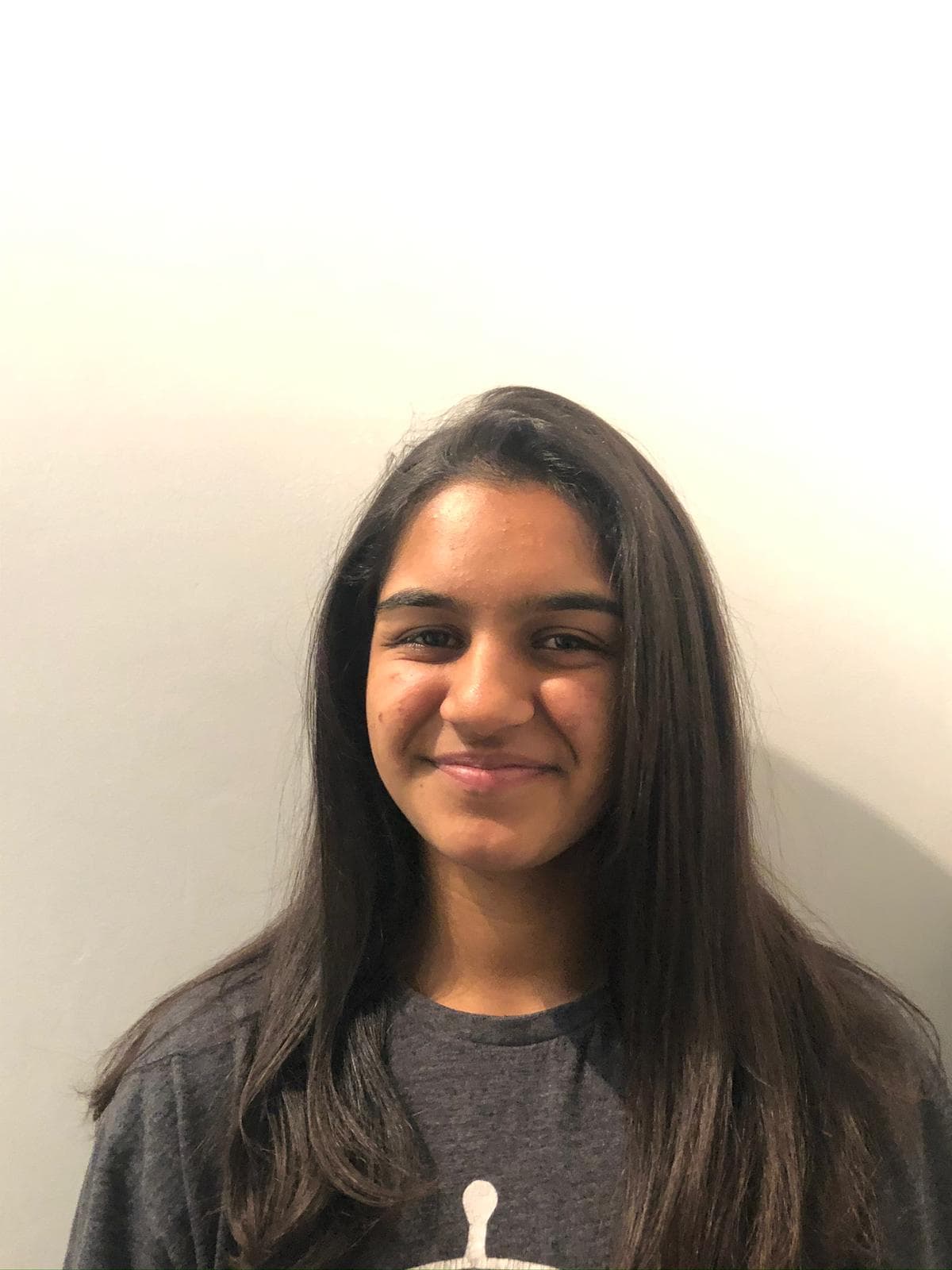 Aalia Shameer Mahomed Against a Wall in a Black Top